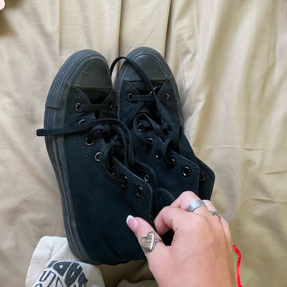 All black high top Converse.